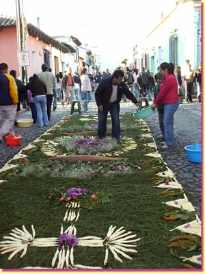 A family shares carpet-making in front of their house ... click to see a large image