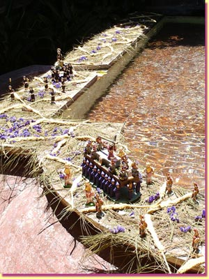 A mini procession rounds the corner around the fountain in Hotel Antigua ... click to see a large image