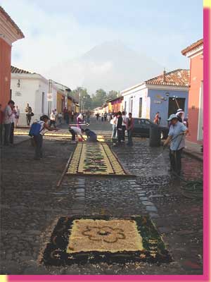 A special carpet, around the corner, to welcome the procession that will destroy it ... Volcano Agua in the dsiatnce - click to see a larger image